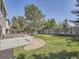 Backyard showcasing a white wooden deck and a well-maintained lawn with a rock feature at 17014 Carr Ave, Parker, CO 80134