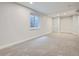 Finished basement featuring a window for natural light and neutral carpet at 17014 Carr Ave, Parker, CO 80134