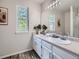 Bright bathroom with double sinks, a large mirror, and stylish fixtures at 17014 Carr Ave, Parker, CO 80134