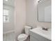 Cozy bathroom featuring a toilet, sink, and window for natural light at 17014 Carr Ave, Parker, CO 80134