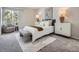 Comfortable bedroom with a queen bed, bench, stylish rug, and decorative lamps at 17014 Carr Ave, Parker, CO 80134