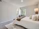 Sunlit bedroom featuring neutral tones, plush carpeting, and a relaxing chair at 17014 Carr Ave, Parker, CO 80134