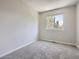 Carpeted bedroom showcasing a window for natural light, wall outlets, and painted walls at 17014 Carr Ave, Parker, CO 80134