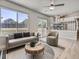Living room featuring neutral decor, hardwood floors, a ceiling fan, and sliding doors to deck at 17014 Carr Ave, Parker, CO 80134