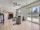 Living room features a brick fireplace, neutral decor, wood floors, a ceiling fan, and sliding doors to deck at 17014 Carr Ave, Parker, CO 80134