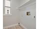 Bright, unfinished room with light wood-look floors, a window, and shelving at 17014 Carr Ave, Parker, CO 80134