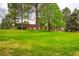 Residential building with a well-manicured lawn and mature trees, offering a serene and inviting setting at 7455 E Quincy Ave # 103, Denver, CO 80237