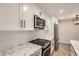 Contemporary kitchen design with white cabinets, subway tile backsplash, and updated appliances at 7455 E Quincy Ave # 103, Denver, CO 80237