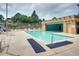 Relaxing community pool with lounge chairs and a covered area for shade on a sunny day at 7455 E Quincy Ave # 103, Denver, CO 80237