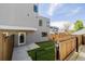 This home boasts a fenced yard with grass, patio, and door access into the modern style home at 2004 S Galapago St, Denver, CO 80223