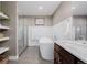 Modern bathroom featuring a soaking tub, glass shower, floating shelves, and marble countertop at 2004 S Galapago St, Denver, CO 80223