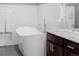 Modern bathroom featuring a freestanding tub and a vanity with a marble countertop at 2004 S Galapago St, Denver, CO 80223