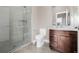 Modern bathroom with a glass-enclosed shower and a vanity with drawers for storage at 2004 S Galapago St, Denver, CO 80223