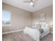 Bright bedroom with a cozy bed, ceiling fan, and natural light from a large window at 2004 S Galapago St, Denver, CO 80223