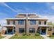 Contemporary home showcasing symmetrical design, brick accents, inviting porches, and lush landscaping creating curb appeal at 2004 S Galapago St, Denver, CO 80223