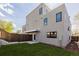 The home features a grassy backyard, a concrete patio, and a private fenced yard at 2004 S Galapago St, Denver, CO 80223