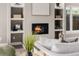 Cozy fireplace surrounded by open shelving and a comfortable sofa adding a touch of elegance to the living space at 2004 S Galapago St, Denver, CO 80223