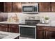 Close up of a stainless steel oven and granite countertop, with modern appliances and ample cabinet space at 2004 S Galapago St, Denver, CO 80223