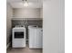 A modern laundry room features side by side washer and dryer with a shelf and recessed lighting at 2004 S Galapago St, Denver, CO 80223