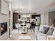 Open living room featuring a cozy fireplace and an adjacent kitchen with stainless steel appliances at 2004 S Galapago St, Denver, CO 80223