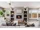 Inviting living room featuring a modern fireplace, neutral color palette, and open shelving perfect for relaxation at 2004 S Galapago St, Denver, CO 80223
