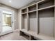 Bright mudroom features built-in storage cubbies, bench and a glass paneled door to the outside at 2004 S Galapago St, Denver, CO 80223