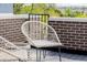 The outdoor patio includes a modern white chair, a small table, and views of the brick perimeter at 2004 S Galapago St, Denver, CO 80223