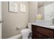 Charming powder room featuring a stylish vessel sink, elegant fixtures, and neutral wall color at 2004 S Galapago St, Denver, CO 80223