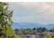 Enjoy sweeping mountain views from the home, framed by lush trees and blue skies at 2004 S Galapago St, Denver, CO 80223