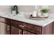 Close up of the wet bar showing marble countertop, dark cabinets, and modern fixtures at 2004 S Galapago St, Denver, CO 80223