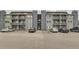 Multi-story building with covered decks, ample parking, and well-maintained landscaping at 8100 W Quincy Ave # 11, Denver, CO 80123