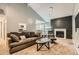 Comfortable living room featuring a fireplace with decorative marble and modern pendant lighting at 8100 W Quincy Ave # 11, Denver, CO 80123