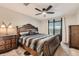 Inviting main bedroom with a decorative headboard, ceiling fan, and a view of the city at 8100 W Quincy Ave # 11, Denver, CO 80123