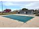 Community pool covered for the off-season near the clubhouse and a blossoming tree at 8100 W Quincy Ave # 11, Denver, CO 80123