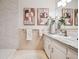 Cozy bathroom with white cabinets, marble countertop, and decorative wall art at 1223 Race St # 101, Denver, CO 80206