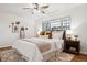 Bright bedroom with a ceiling fan, wooden floors and a large comfortable bed at 1223 Race St # 101, Denver, CO 80206