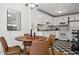 Eat-in kitchen with white cabinetry, black and white tiled floors, and stainless steel appliances at 1223 Race St # 101, Denver, CO 80206