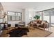 Bright living room with modern furnishings, neutral paint, and a large window with views at 1223 Race St # 101, Denver, CO 80206