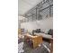 A sun-drenched patio area with a wooden table and stylish outdoor furniture at 1223 Race St # 101, Denver, CO 80206