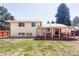 Spacious backyard featuring a deck, lush lawn, mature trees, and privacy fence at 11647 E Wesley Ave, Aurora, CO 80014