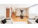 Finished basement with hardwood floors, exercise bike and comfortable seating area at 11647 E Wesley Ave, Aurora, CO 80014