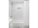 Bright bathroom featuring a tiled shower and tub with a shower niche at 11647 E Wesley Ave, Aurora, CO 80014