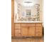 Bathroom featuring a wood vanity with a granite countertop and tiled backsplash at 11647 E Wesley Ave, Aurora, CO 80014