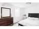 Bright bedroom featuring a comfortable bed, dark wood dresser, and neutral decor at 11647 E Wesley Ave, Aurora, CO 80014