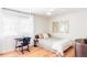 Bright bedroom with hardwood floors, a desk, a ceiling fan, and a window at 11647 E Wesley Ave, Aurora, CO 80014