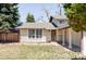 Inviting single-Gathering home featuring a covered entryway, large windows, and mature trees at 11647 E Wesley Ave, Aurora, CO 80014
