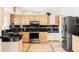 Spacious kitchen with custom cabinetry, stainless steel appliances, and granite countertops at 11647 E Wesley Ave, Aurora, CO 80014