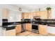 Well-equipped kitchen featuring granite countertops, stainless steel appliances, and ample cabinet space at 11647 E Wesley Ave, Aurora, CO 80014