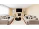 Bright living room featuring hardwood floors, modern furniture, and a stone fireplace at 11647 E Wesley Ave, Aurora, CO 80014