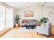 Sunlit living room with wood floors, modern decor, and stylish furnishings at 11647 E Wesley Ave, Aurora, CO 80014